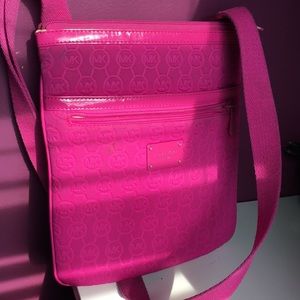 Hot pink crossbody Michael Kors bag.